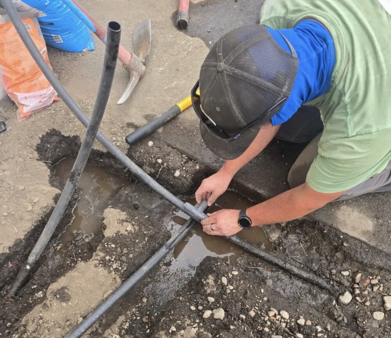 Technician repairing a lawn sprinkler line