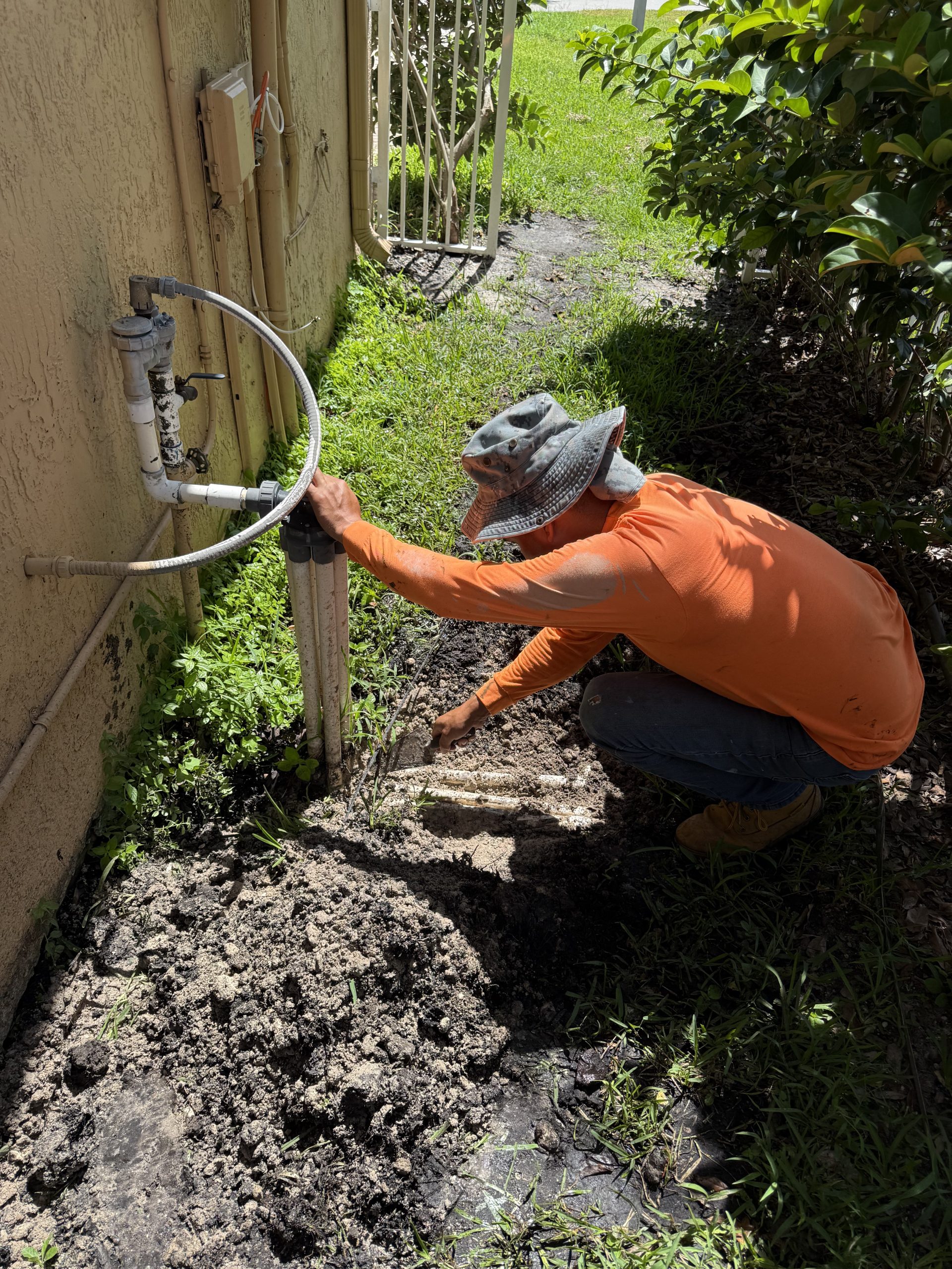 Landscape irrigation system installed around planted beds